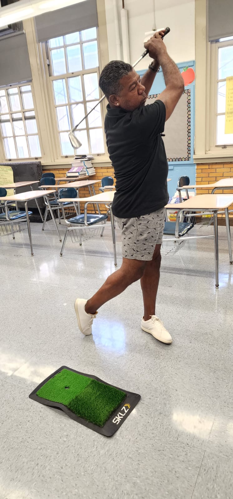 Miguel Martinez demonstrating a golf swing during a Golf as an Etiquette Sport session